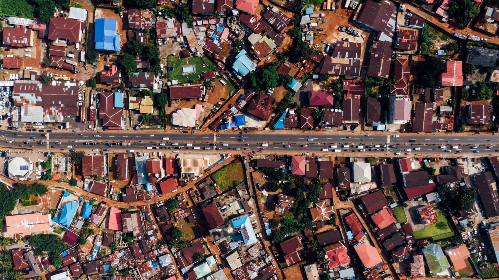 An aerial view of a Nigerian community at the edge of open country. The Oriire schools sat between farmland and forest, the terrain mass kidnapping has always exploited.